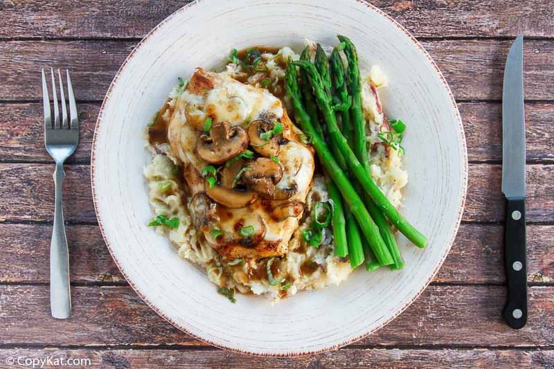 homemade Cheesecake Factory Chicken Madeira, mashed potatoes, and asparagus on a plate