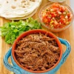 beef barbacoa, cilantro, salsa, tortillas, and sour cream