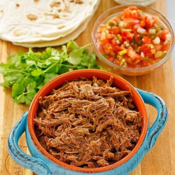 beef barbacoa, cilantro, salsa, tortillas, and sour cream