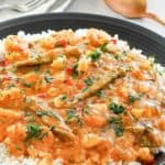 seafood gumbo over rice in a black bowl