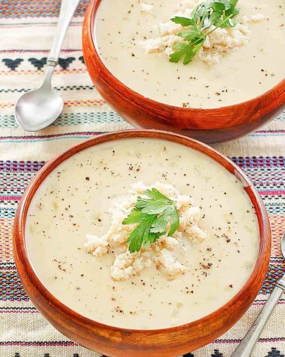 two bowls of crab bisque and two spoons