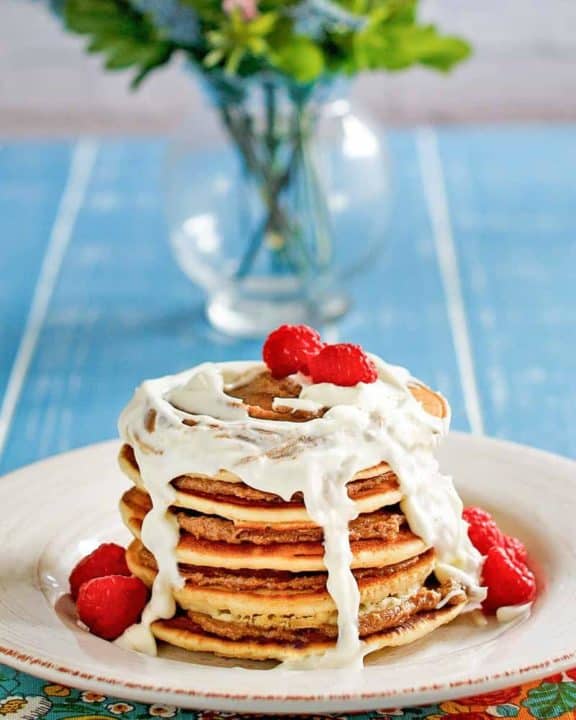 a stack of homemade IHOP Cinnastack pancakes with cream cheese icing