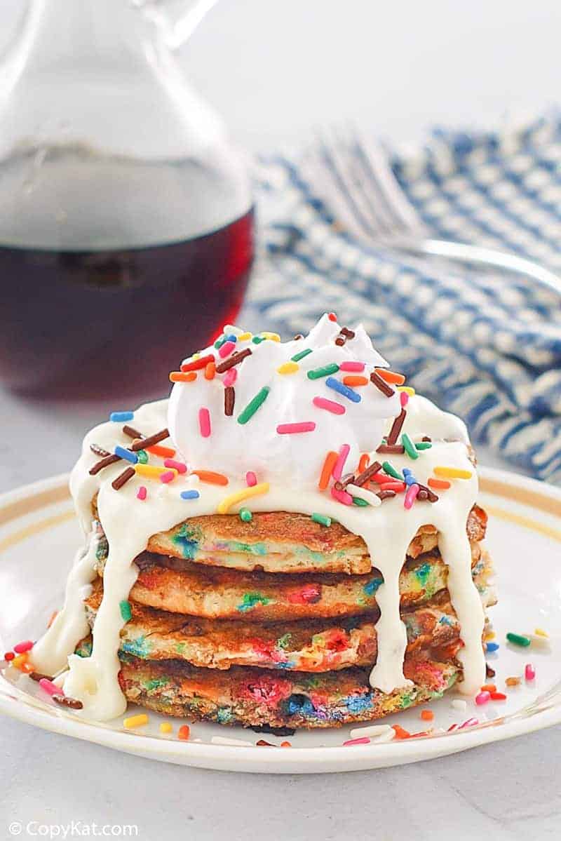 a stack of homemade IHOP cupcake pancakes with icing and syrup