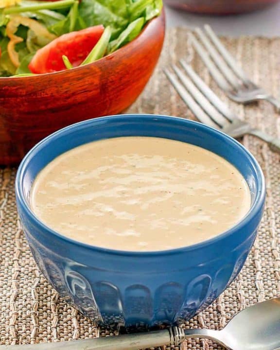 a bowl of homemade Russian dressing and a salad