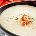 a bowl of she crab soup topped with crabmeat and crab roe