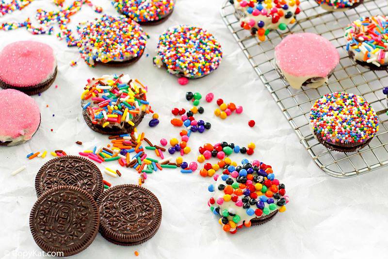 Oreo cookies topped with white chocolate and candy sprinkles