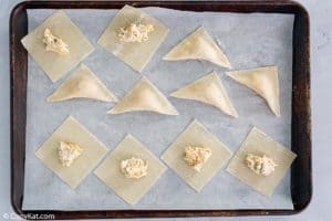 wonton jalapeno poppers before frying on a baking sheet
