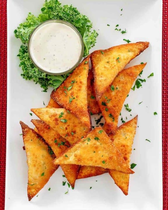 wonton jalapeno poppers and dip on a platter