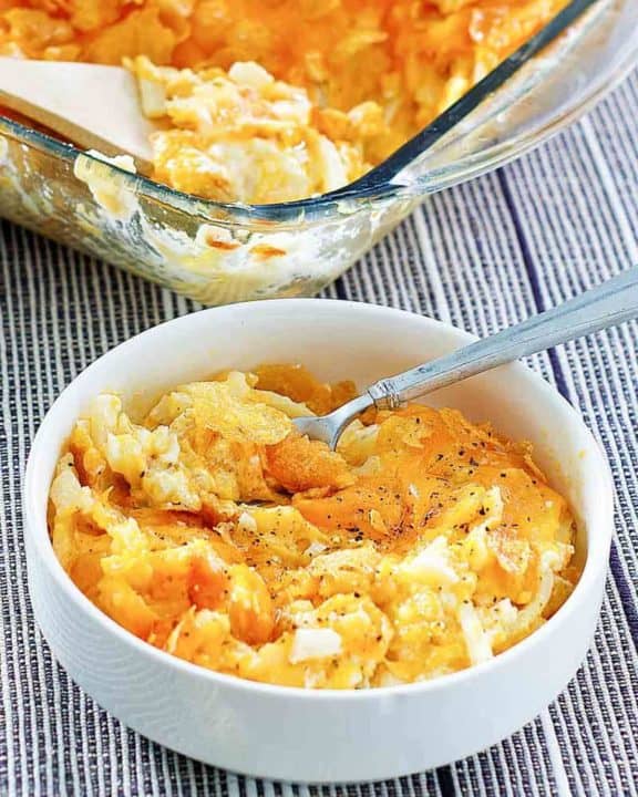 cheesy hashbrown potato casserole in a bowl and baking dish