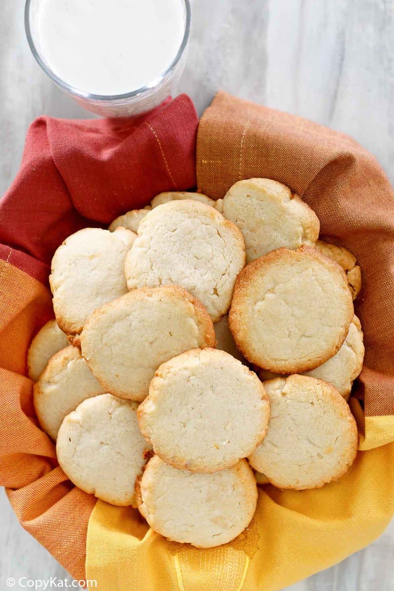 a basket of cream cheese cookies and a glass of milk