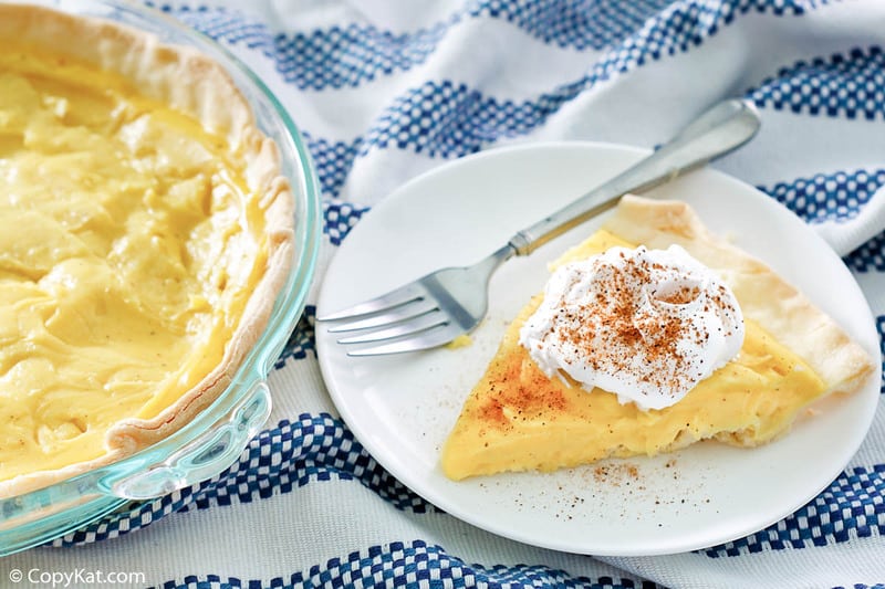 eggnog pie slice topped with whipped cream and nutmeg
