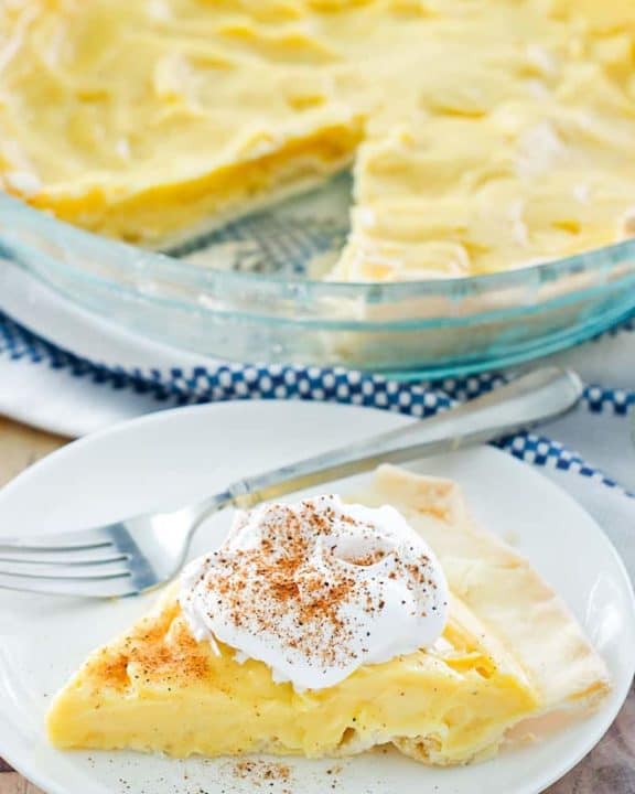 eggnog pie slice on a plate in front of the pie