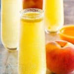 homemade Harry's Bar Bellini cocktails, fresh peaches, and peach puree