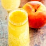 homemade Harry's Bar Bellini, a fresh peach, and peach puree