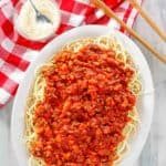 overhead view of homemade Olive Garden Bolognese over pasta on a platter