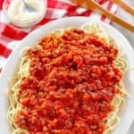 homemade Olive Garden Beef Bolognese over pasta on a platter