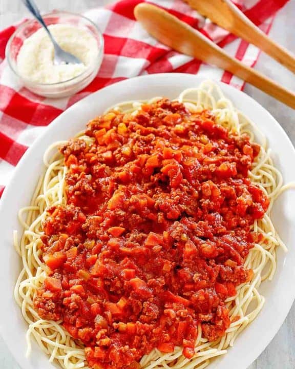 homemade Olive Garden Beef Bolognese over pasta on a platter