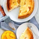 overhead view of homemade Olive Garden Peaches and Cream Cheesecake and peach slices