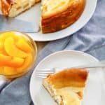 a slice of peach cheesecake and a bowl of peaches, and peach cheesecake