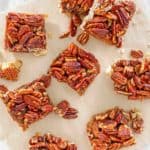 overhead view of pecan pie bars on parchment paper