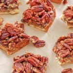 pecan pie bars on brown parchment paper