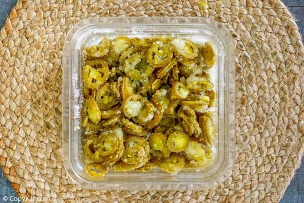 pickled jalapenos and sugar in a container
