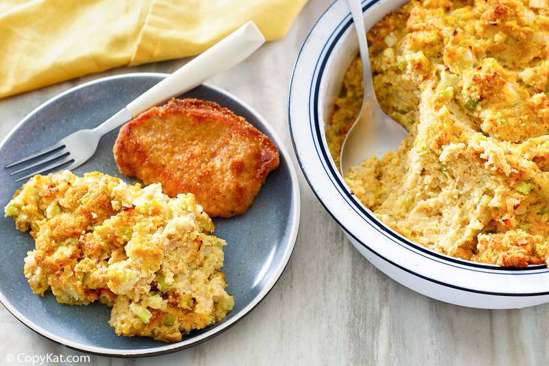 southern cornbread dressing in a baking dish and on a plate with a pork chop