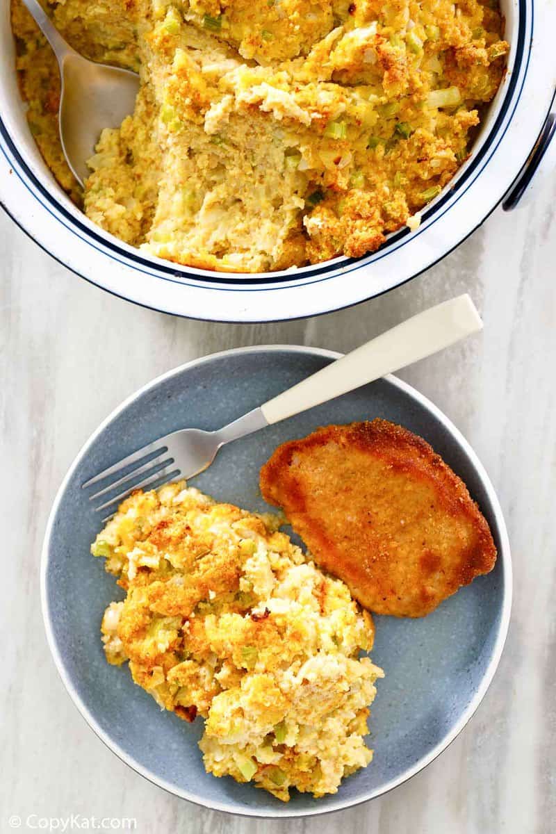southern cornbread dressing and a pork chop on a plate