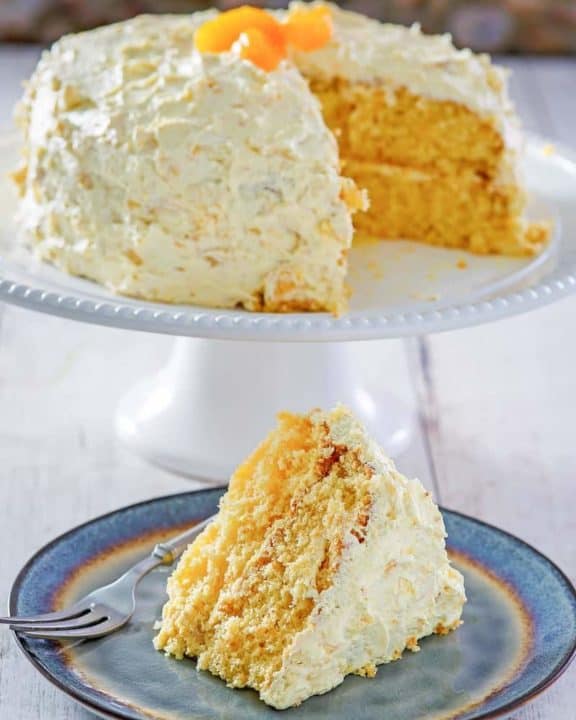Ambrosia Cake on a cake stand and a slice on a plate