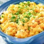 creamed corn topped with sliced green onions in a serving dish