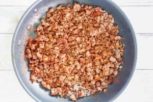 browned ground beef with 2 alarm chili seasonings in a skillet