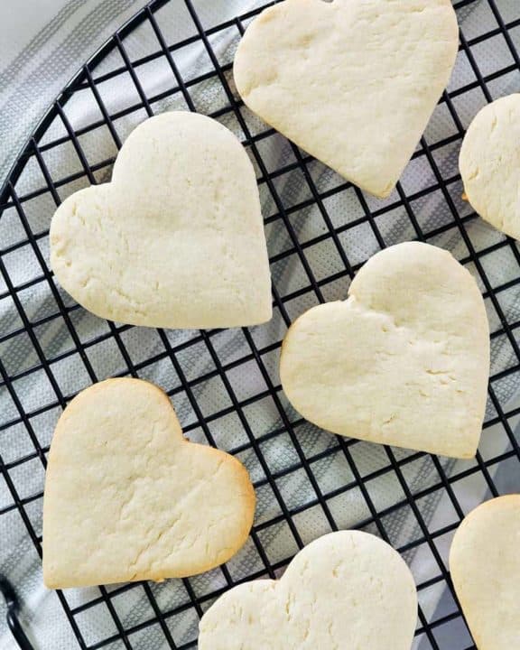 overhead view of heart-shaped cake mix cookies on a cooling rack