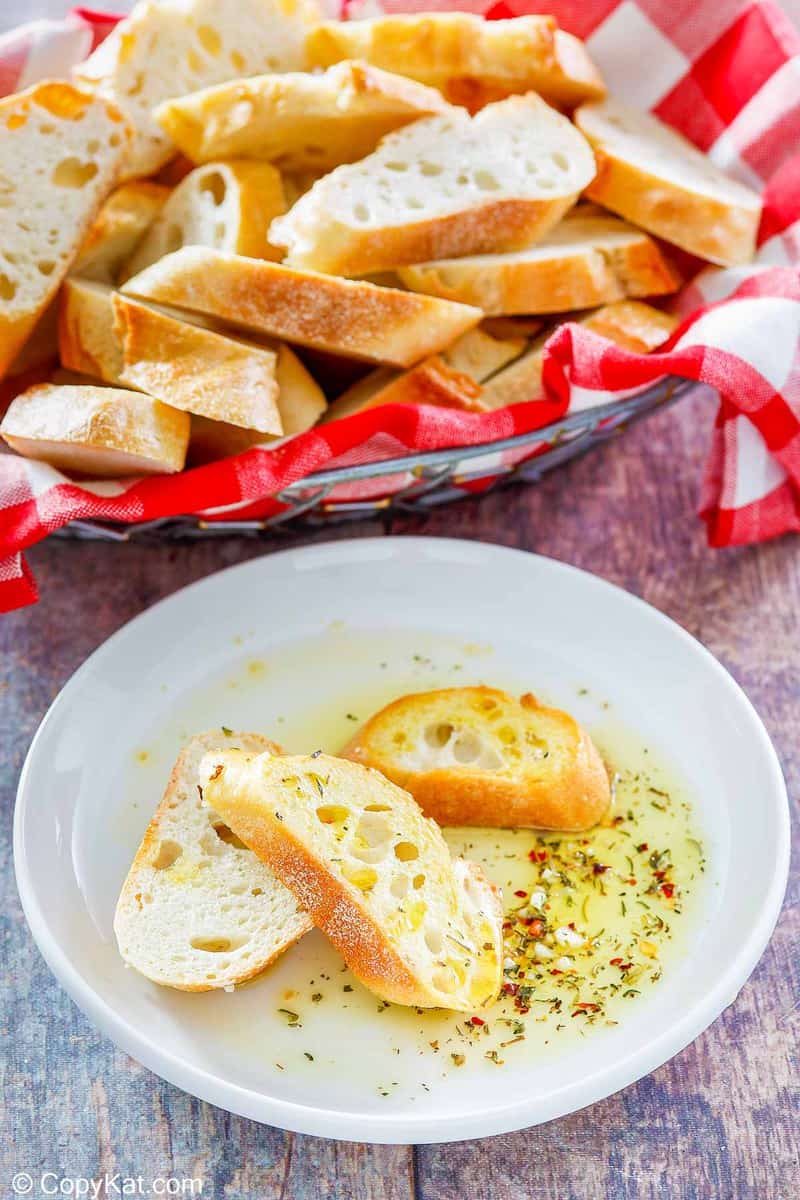 homemade Carrabba's Italian Butter Spicy Sicilian dipping sauce on a plate and bread slices