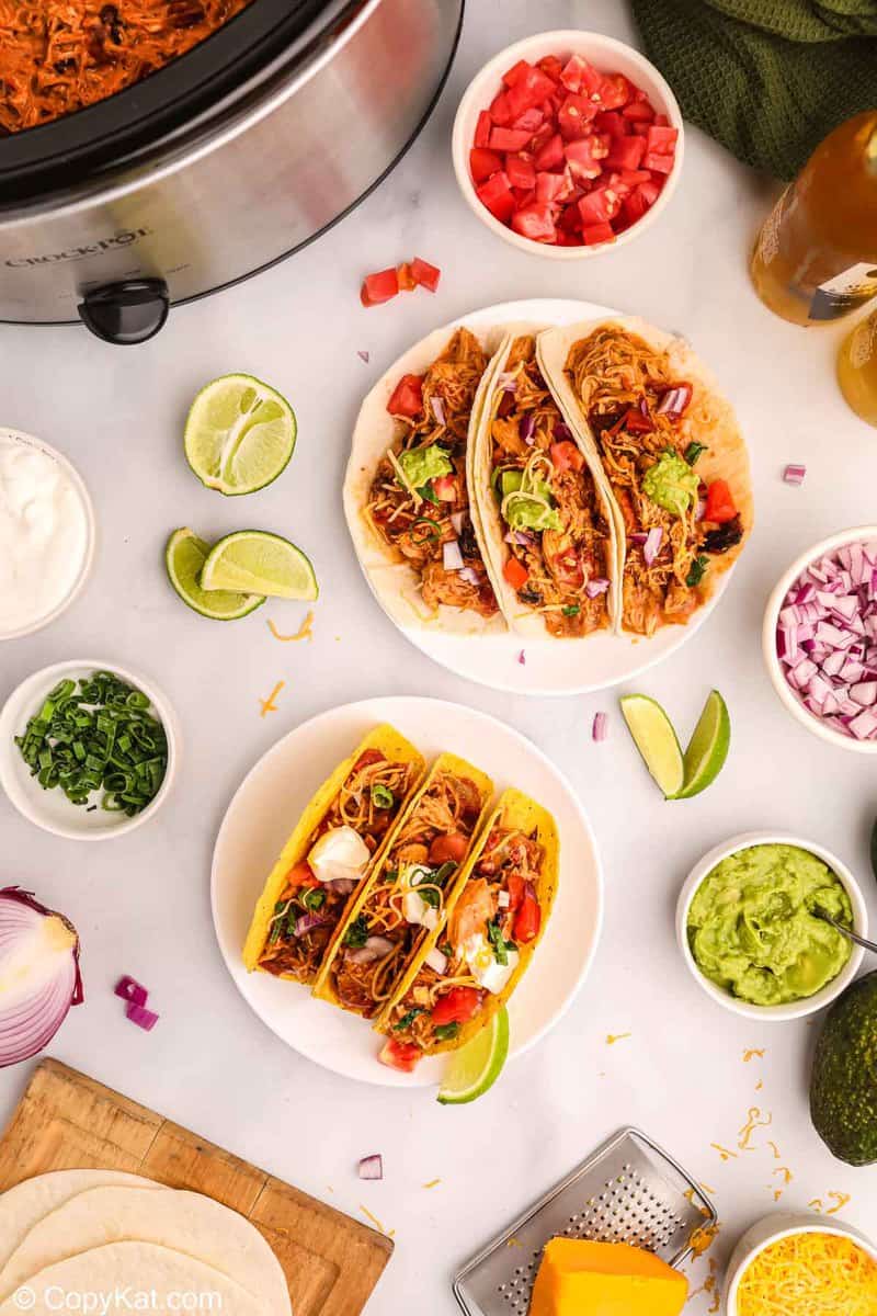 overhead view of Crockpot chicken tacos and assorted toppings