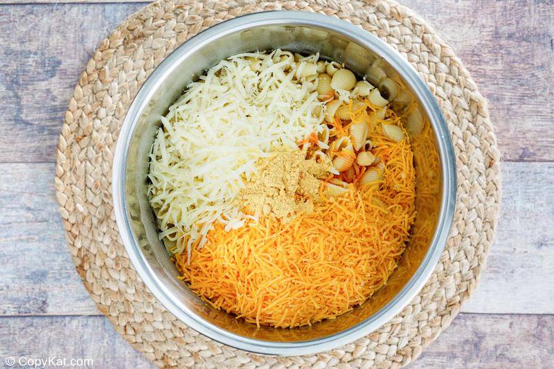 cooked pasta, cheese, and seasonings in an Instant Pot bowl