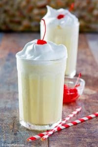 Homemade McDonald's eggnog shake with whipped cream and a cherry on top