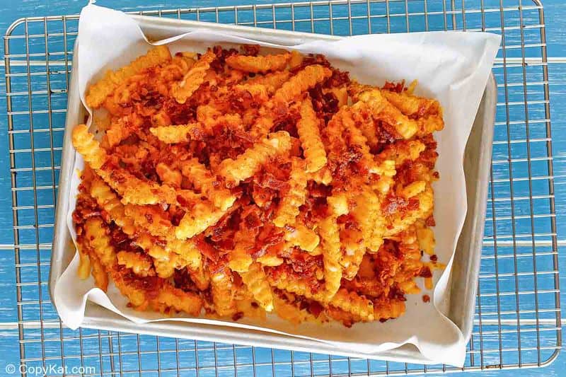Homemade Outback Steakhouse Aussie Fries on a baking sheet and cooling rack