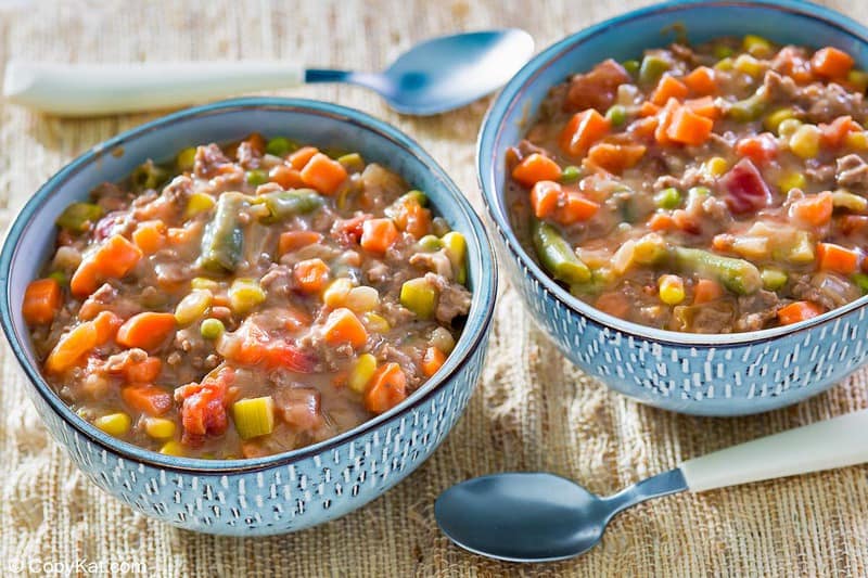two bowls of homemade Plaza III steak soup and two spoons