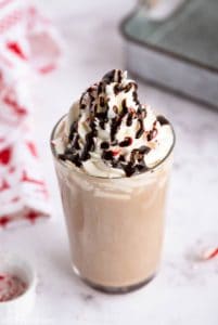 homemade Starbucks peppermint mocha topped with whipped cream, chocolate syrup, and peppermint candy
