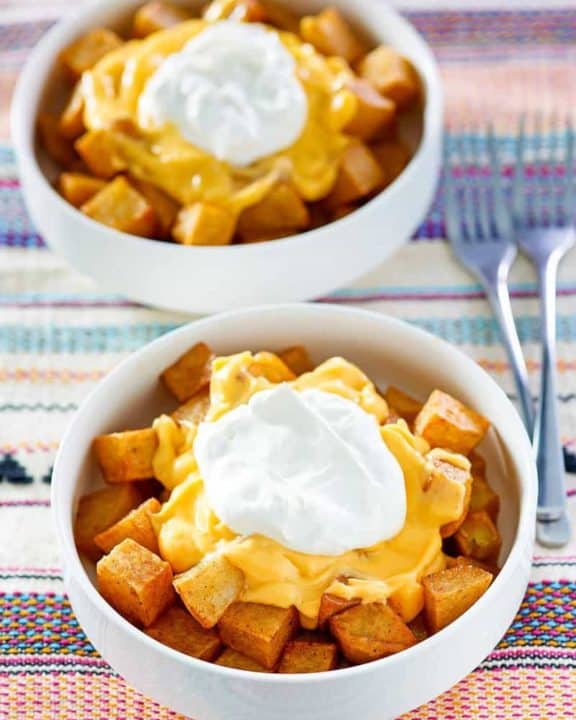two bowls of homemade Taco Bell Cheesy Fiesta Potatoes bowls