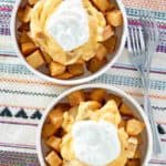 Overhead view of two bowls of homemade Taco Bell Cheesy Fiesta Potatoes