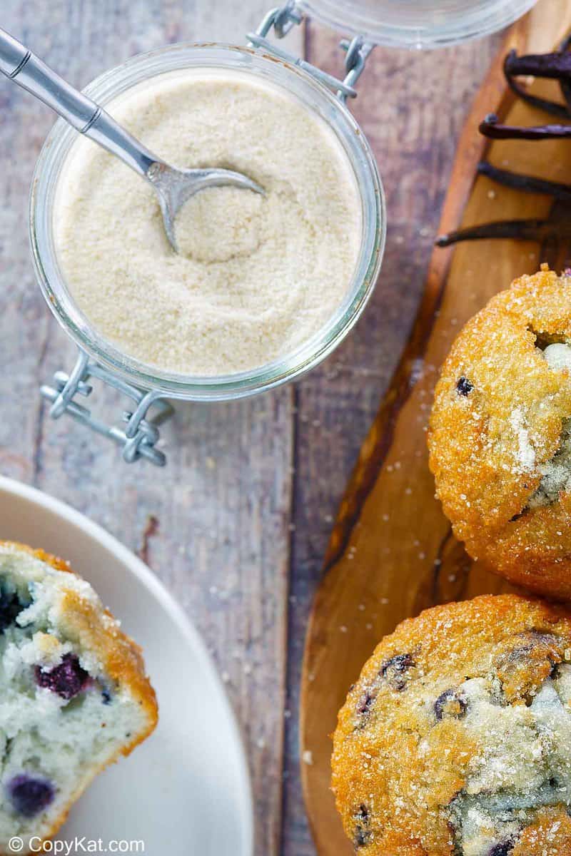 overhead view of a jar of homemade vanilla sugar and blueberry muffins