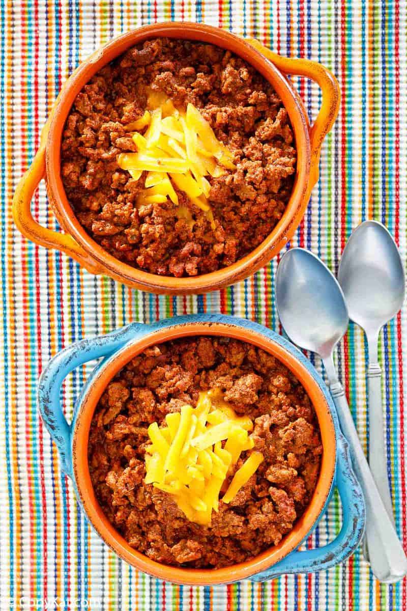 overhead view of two bowls of homemade Wick Fowler 2 Alarm Chili