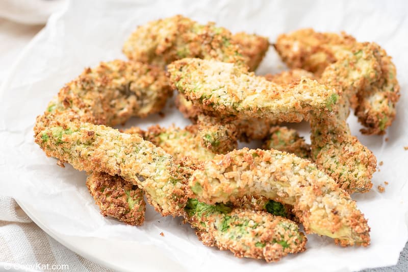 air fryer avocado fries on a paper towel lined plate