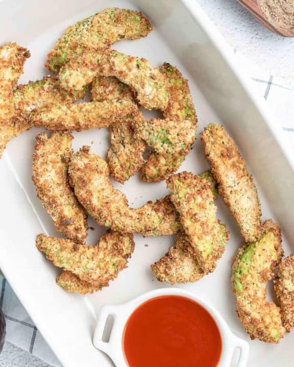 overhead view of air fryer avocado fries in a serving dish