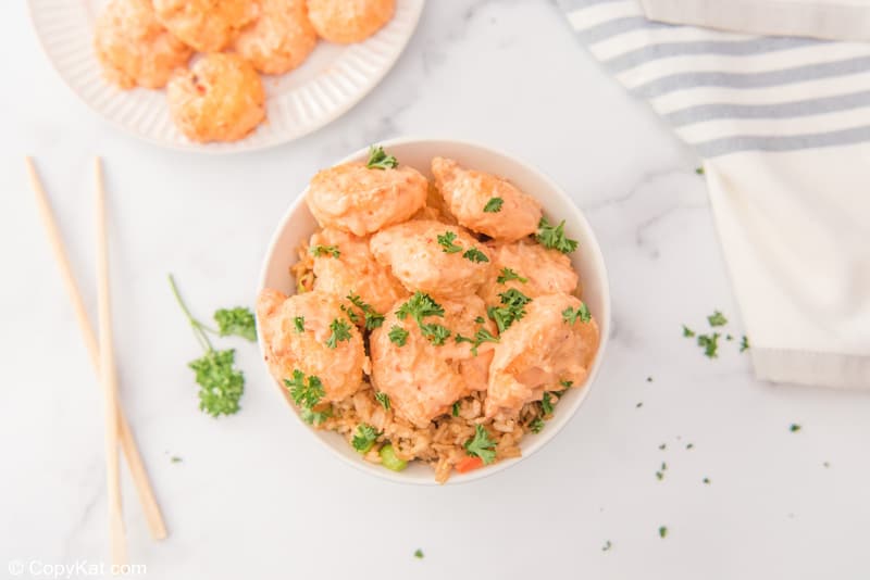 air fryer bang bang shrimp with creamy chili sauce and rice in a bowl