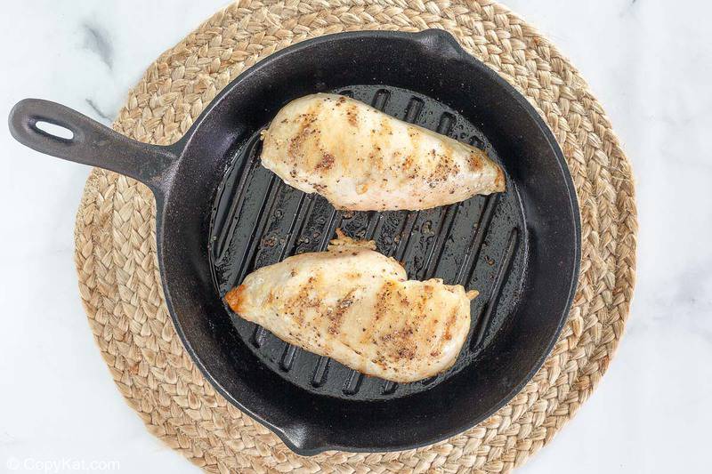 cooked chicken breasts in a grill pan