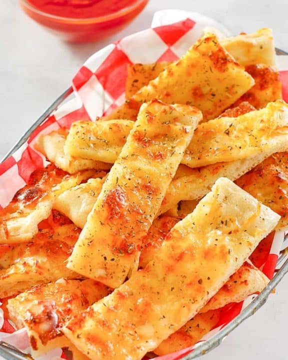 a basket of homemade Little Caesar's Italian cheese breadsticks