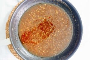 New Orleans shrimp and grits sauce in a skillet