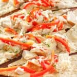 homemade Olive Garden grilled chicken flatbread on a wood board